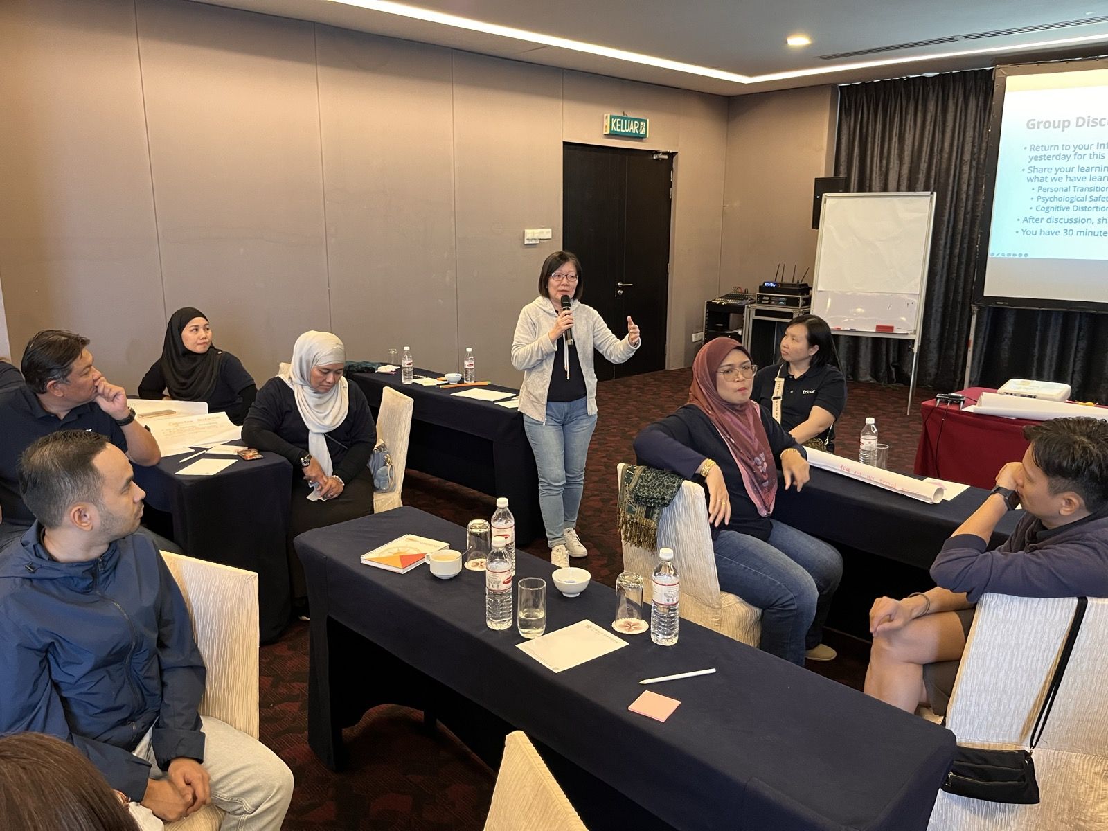 Participants in a classroom discussion circle with the facilitator