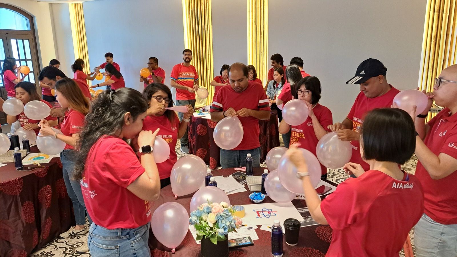Participants laughing during a balloon energiser in a Positive Psychology session