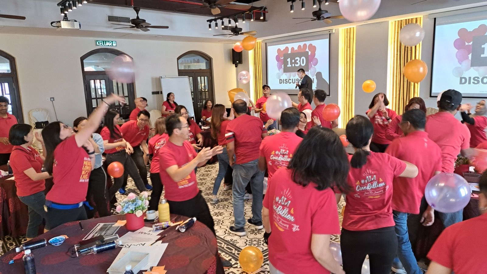 A large group of participants in an energiser during an Experiential Learning session