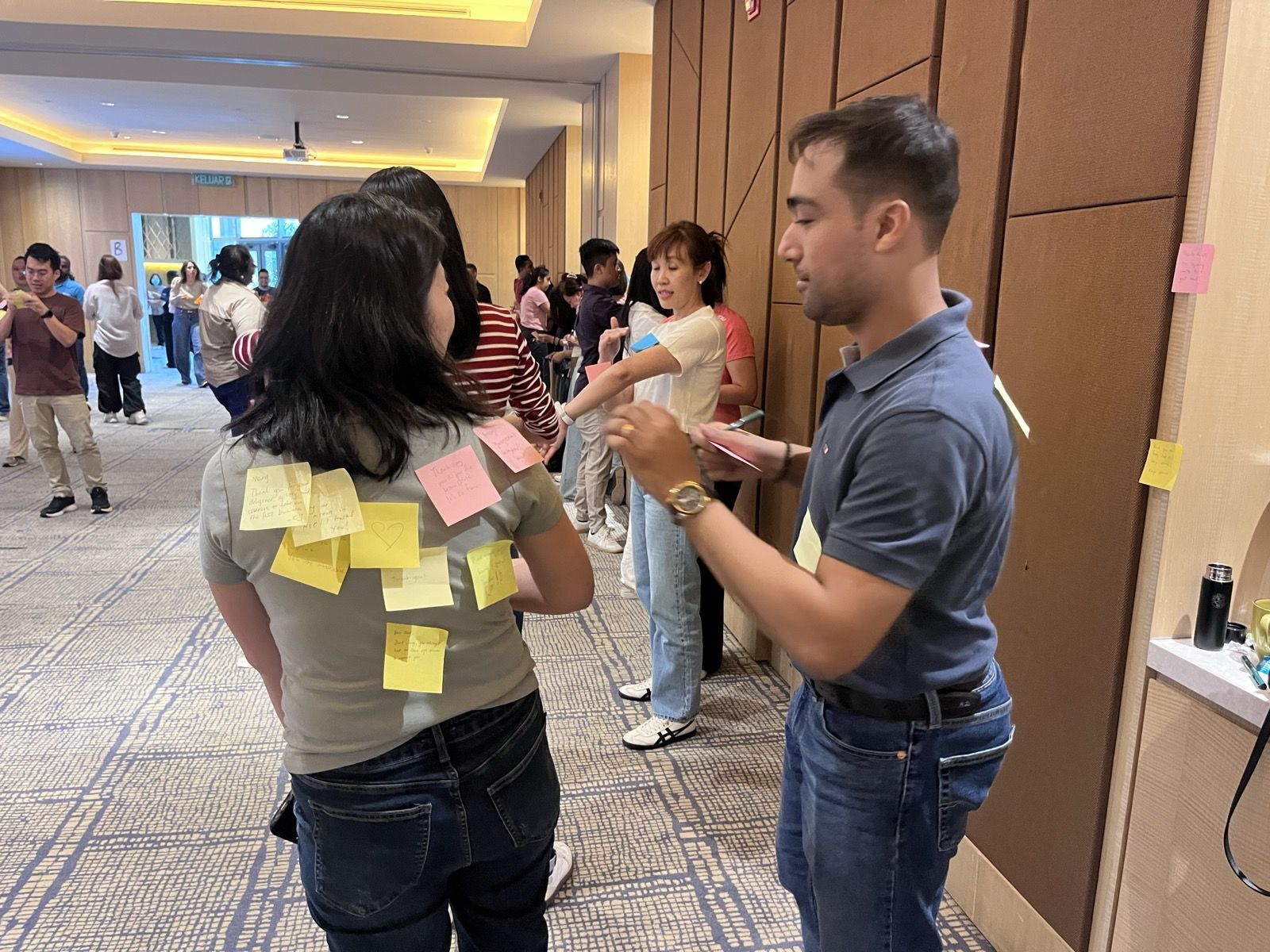 Participants giving each other sticky-note feedback