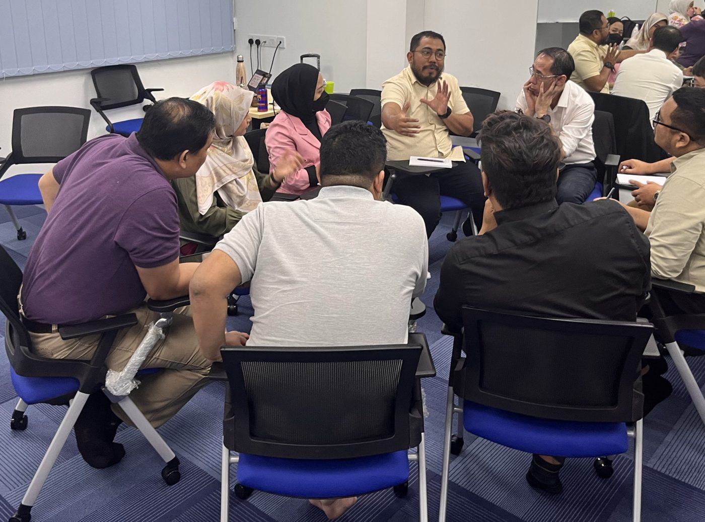 Participants sharing ideas in a group coaching circle